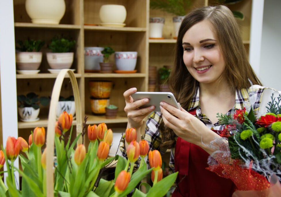 flower shop owner taking photos